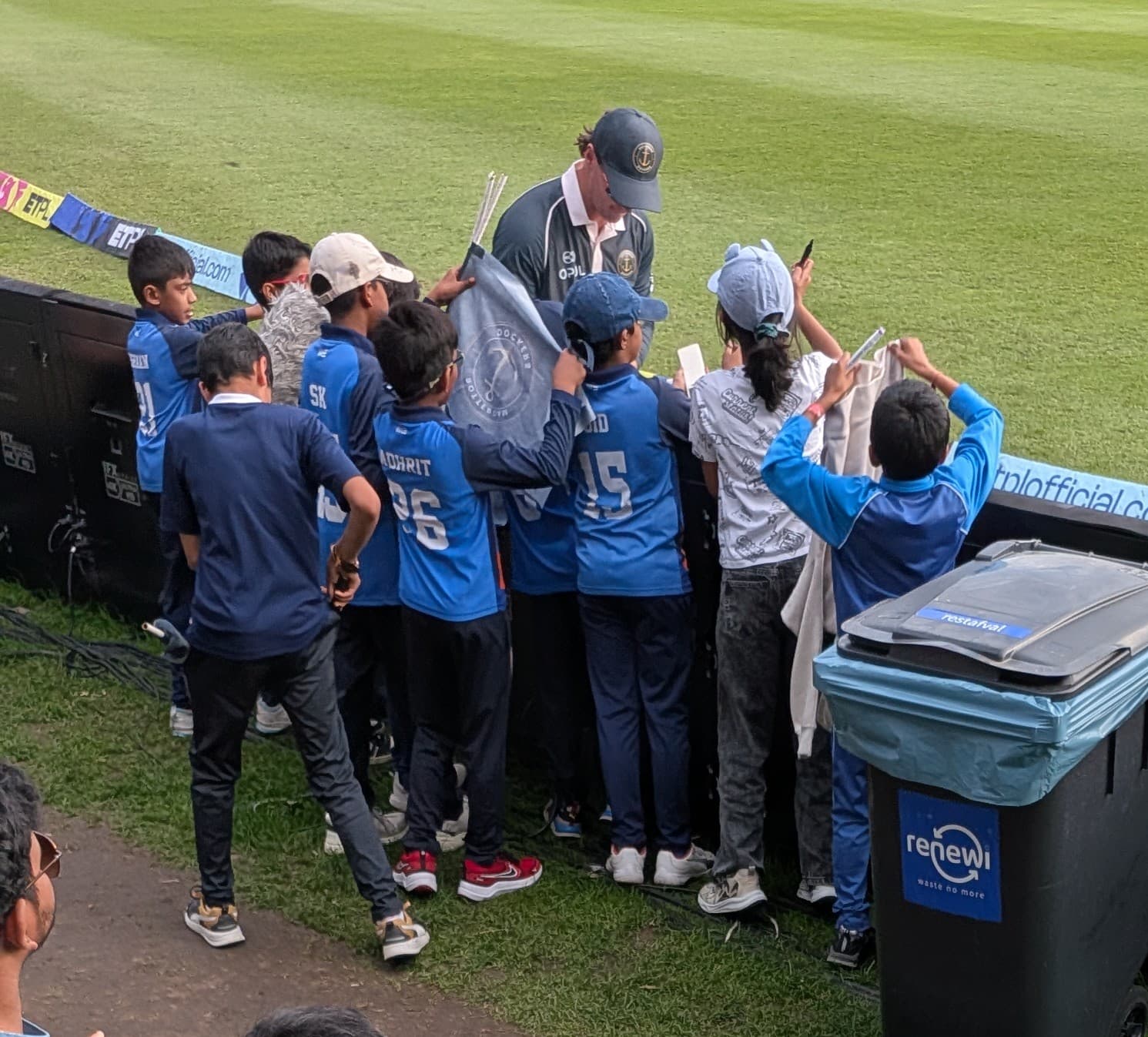 ECC youngsters meeting a cricket player and collecting autographs at the boundary